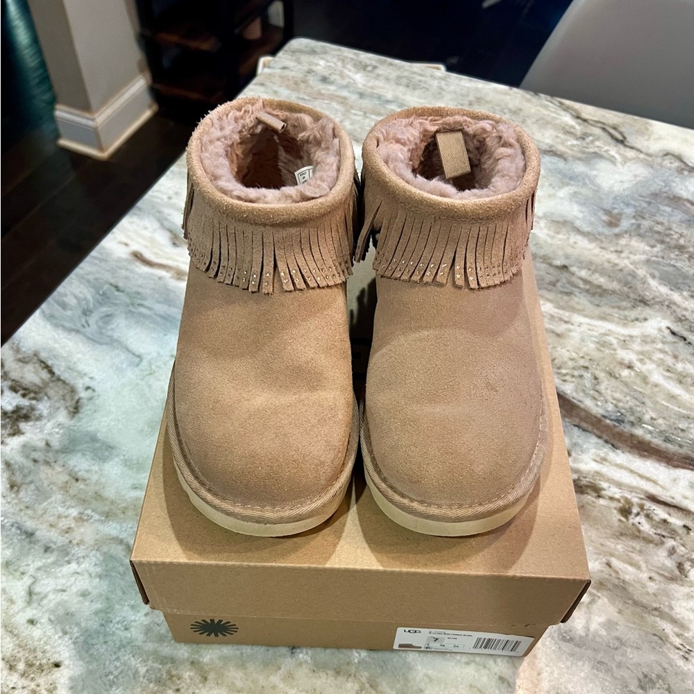 UGG Classic Ultra Mini with decorative trim around the top.